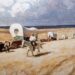 Huifkarren trekken naar het westen. Schilderij door Newell Convers Wyeth, begin twintigste eeuw.