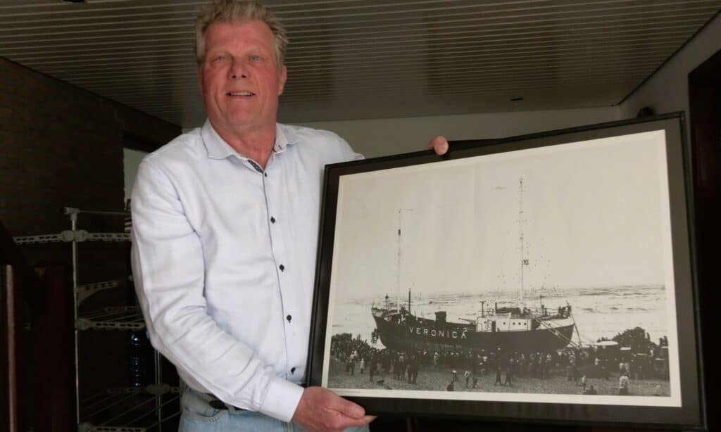 Leo Wijers met een foto van zeezender Radio Veronica.