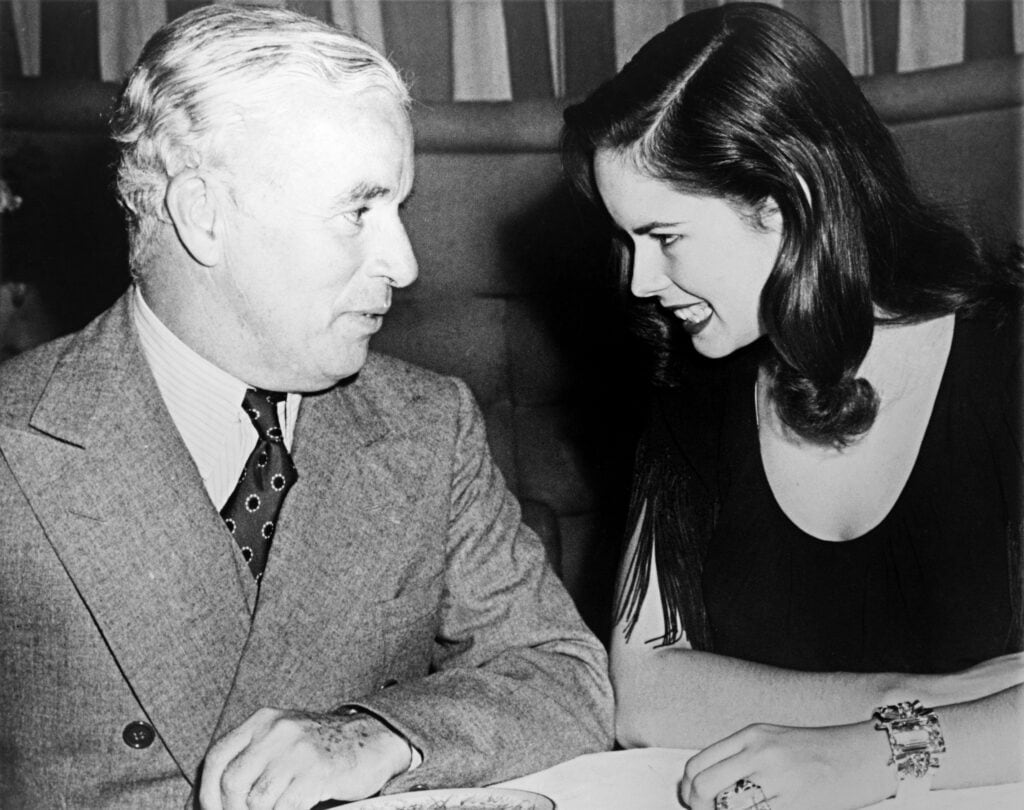 Charlie and Oona Chaplin, Associated Press photo, 1944 Charlie Chaplin sitting with wife Oona at Hollywood nightclub. Associated Press photo, 1944.