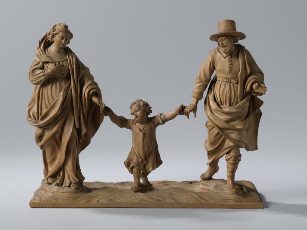 Josef en Maria lijken op het punt te staan om hun zoontje de lucht in te zwiepen op deze houten beeldengroep door Jan van Doorne, circa 1640-1650.